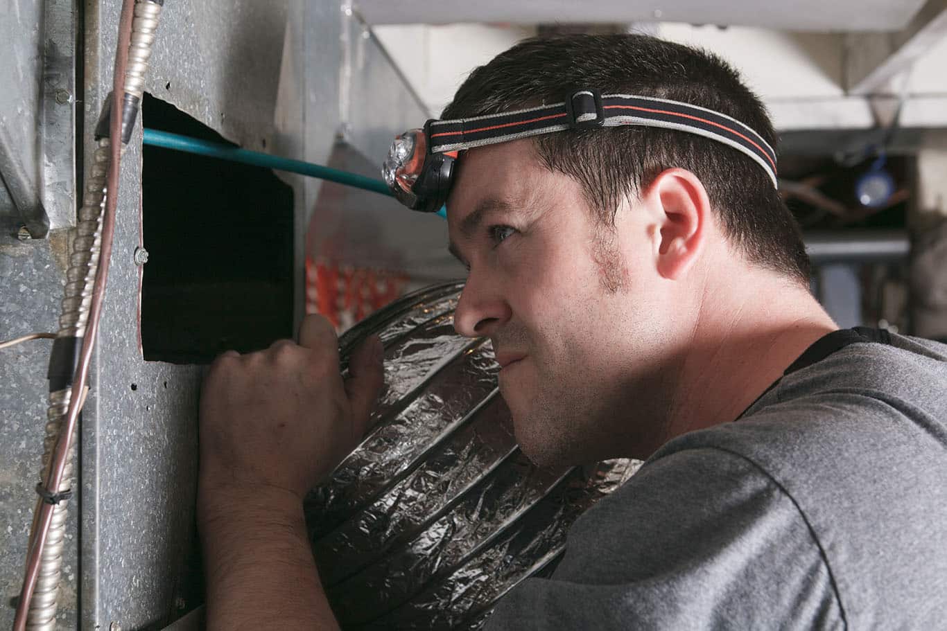 Technician inspecting for Aeroseal Duct Sealing in Mesa, AZ